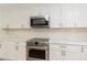 Bright kitchen features white cabinets, stainless steel appliances, and quartz countertops at 14319 Morristown Ave, Port Charlotte, FL 33981