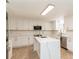 Bright kitchen features white cabinets, stainless steel appliances, and spacious island with quartz countertops at 14319 Morristown Ave, Port Charlotte, FL 33981