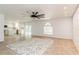 Bright living room with a view of the kitchen, patio doors and brick accent wall at 14319 Morristown Ave, Port Charlotte, FL 33981