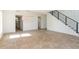 Open-concept living room boasts tile floors and a modern staircase with black metal railings at 14319 Morristown Ave, Port Charlotte, FL 33981