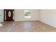 Entryway and living room feature tile flooring and plenty of natural light from the windows and door at 14319 Morristown Ave, Port Charlotte, FL 33981