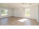 Bright living room featuring tile flooring, recessed lights and two windows offering lots of natural light at 14319 Morristown Ave, Port Charlotte, FL 33981