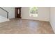 Bright living room showcases tile flooring, a modern staircase with metal railings, and a large window at 14319 Morristown Ave, Port Charlotte, FL 33981
