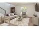 Virtually staged living room features ample natural light, contemporary staircase, and stylish furniture at 14319 Morristown Ave, Port Charlotte, FL 33981