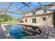 A screened in pool with brick patio and clear blue water at 14319 Morristown Ave, Port Charlotte, FL 33981