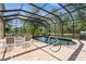 Enclosed pool with seating area and outdoor grill at 14319 Morristown Ave, Port Charlotte, FL 33981