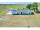 Ariel view of single story ranch house with a covered front porch and storage shed at 14655 Joe Sumner Rd, Wimauma, FL 33598