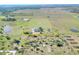 Expansive property with a charming home nestled within a picturesque, open landscape with a pond at 14655 Joe Sumner Rd, Wimauma, FL 33598