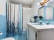 Classic blue bathroom with a shower, vanity, and built-in storage, offering a clean and functional space at 14655 Joe Sumner Rd, Wimauma, FL 33598
