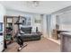 Bonus room with neutral color palette, couch, workout equipment, and small desk at 14655 Joe Sumner Rd, Wimauma, FL 33598