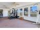 Large bonus room filled with workout equipment and pastoral views at 14655 Joe Sumner Rd, Wimauma, FL 33598