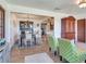 Charming dining room featuring a dark hutch, chandelier, and bright chairs, perfect for Gathering meals at 14655 Joe Sumner Rd, Wimauma, FL 33598