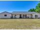 A bright exterior featuring a lovely porch offering an idyllic space for relaxation and welcoming guests at 14655 Joe Sumner Rd, Wimauma, FL 33598