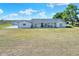 Sprawling single story ranch with covered front porch and adjacent storage shed at 14655 Joe Sumner Rd, Wimauma, FL 33598