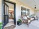 Inviting front porch with comfortable wicker seating, creating a warm and welcoming entrance to the home at 14655 Joe Sumner Rd, Wimauma, FL 33598