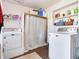 Convenient laundry room with washer, dryer, and ample storage space at 14655 Joe Sumner Rd, Wimauma, FL 33598