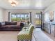 Comfortable living room with a large window and modern decor, ideal for relaxation and entertaining guests at 14655 Joe Sumner Rd, Wimauma, FL 33598