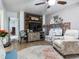 Inviting living room with a wood-paneled accent wall and brick fireplace, ideal for relaxation and gatherings at 14655 Joe Sumner Rd, Wimauma, FL 33598