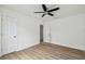 Neutral bedroom with ceiling fan, new flooring, baseboard trim, and closet at 15621 Bertram Dr, Hudson, FL 34667