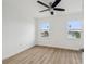 Bright bedroom features fresh white walls, new wood floors, and a ceiling fan at 15621 Bertram Dr, Hudson, FL 34667