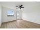 Spacious bedroom features a ceiling fan, and a glass door to outdoor balcony at 15621 Bertram Dr, Hudson, FL 34667