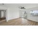 Spacious bedroom with ceiling fan, new floors, sliding glass door, and canal views at 15621 Bertram Dr, Hudson, FL 34667