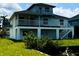 Waterfront home featuring multiple decks, white facade, and dock access on the canal at 15621 Bertram Dr, Hudson, FL 34667