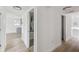 Hallway view featuring a kitchen to the left, laundry area, and hallway closet at 15621 Bertram Dr, Hudson, FL 34667