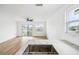 Open-concept kitchen featuring an island with sink, leading into a living area with access to a canal-view balcony at 15621 Bertram Dr, Hudson, FL 34667