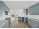 Open kitchen with light gray cabinets, modern countertops, and wood-look flooring at 15621 Bertram Dr, Hudson, FL 34667
