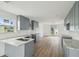 Bright kitchen with white countertops, gray cabinetry, new floors, and recessed lighting at 15621 Bertram Dr, Hudson, FL 34667