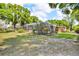 Expansive backyard featuring a screened-in patio and lush landscaping, perfect for relaxation and outdoor gatherings at 18826 Huckavalle Rd, Odessa, FL 33556