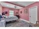 Comfortable bedroom with a ceiling fan, bright lighting, and a colorful accent rug at 18826 Huckavalle Rd, Odessa, FL 33556