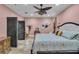Comfortable bedroom featuring elegant decor, a ceiling fan, and stylish furnishings at 18826 Huckavalle Rd, Odessa, FL 33556