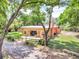 Expansive backyard with a patio, new sod, mature trees, and a fenced-in yard at 18826 Huckavalle Rd, Odessa, FL 33556