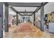 Grand foyer featuring a beautiful chandelier, tile flooring, and striking architectural beams at 18826 Huckavalle Rd, Odessa, FL 33556