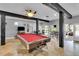 Recreation room with a pool table, bar area, and ceiling fan, perfect for entertaining guests at 18826 Huckavalle Rd, Odessa, FL 33556