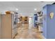 Open kitchen with stainless steel appliances, wood cabinets, and tile floors at 18826 Huckavalle Rd, Odessa, FL 33556