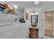 Functional laundry area featuring a modern washer and dryer, sink, and storage shelving at 18826 Huckavalle Rd, Odessa, FL 33556