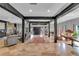 Open-concept living room with dark wooden beams, travertine floors, and views to other rooms at 18826 Huckavalle Rd, Odessa, FL 33556