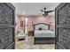 Elegant bedroom with detailed doors, fan, and decorative lamps at 18826 Huckavalle Rd, Odessa, FL 33556