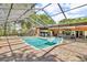 Backyard pool with attached screened enclosure with furniture, spa, and outdoor grill at 18826 Huckavalle Rd, Odessa, FL 33556