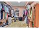 Spacious walk-in closet with ample storage shelves and racks for clothing and accessories at 18826 Huckavalle Rd, Odessa, FL 33556