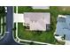 Aerial view of a well-maintained property with lush landscaping, a driveway, and a screened patio at 1920 Folkstone Pl, Wesley Chapel, FL 33543