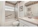 Cozy bathroom with tiled shower-tub, decorative border, and convenient vanity sink at 1920 Folkstone Pl, Wesley Chapel, FL 33543