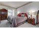 Cozy bedroom featuring a comfortable bed, elegant bedside tables, and sliding door access to the lanai at 1920 Folkstone Pl, Wesley Chapel, FL 33543