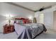Comfortable bedroom featuring carpeted floors and an attached bathroom at 1920 Folkstone Pl, Wesley Chapel, FL 33543