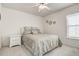 Cozy bedroom with carpet floors, ceiling fan, and window at 1920 Folkstone Pl, Wesley Chapel, FL 33543