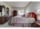 Comfortable bedroom featuring an abundance of wood details and natural light at 1920 Folkstone Pl, Wesley Chapel, FL 33543