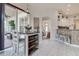 Eat-in kitchen nook with breakfast table and seating, and access to a screened lanai with sliding glass doors at 1920 Folkstone Pl, Wesley Chapel, FL 33543